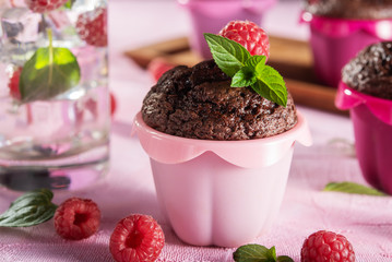 Sweet chocolate cupcake on pink background