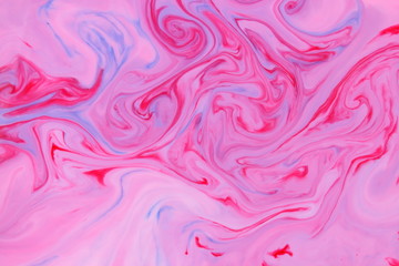 Pink blue abstract background, pink stains on the liquid, multi-colored pattern, food colors in the milk, color texture on the water, preparation for the designer