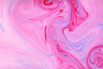 Fototapeta na wymiar Pink blue abstract background, pink stains on the liquid, multi-colored pattern, food colors in the milk, color texture on the water, preparation for the designer