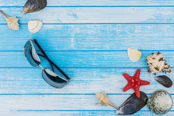 Sea Shells Decorations Sunglasses And Sea Star On Blue And White Painted  Wood Background High Contrast Summer Concept