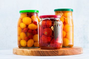 Harvest of red and yellow tomatoes, closed in cans for preservation and fermentation. Autumn...