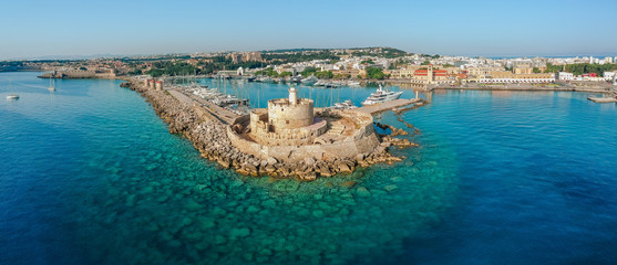 Aerial birds eye view drone photo of Rhodes city island, Dodecanese, Greece. Panorama with Mandraki port, lagoon and clear blue water. Famous tourist destination in South Europe - obrazy, fototapety, plakaty