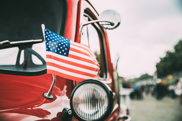 Close Side View Of Red Pickup Truck With Small American Flag Waving © Great Brut Here