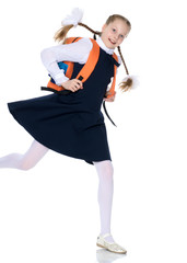 A little girl is hurrying to school.