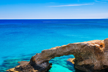 Beautiful natural rock arch near of Ayia Napa, Cavo Greco and Protaras on Cyprus island, Mediterranean Sea. Legendary bridge lovers. Amazing blue green sea and sunny day.