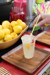 a refreshing cup of freshly made lemonade with a bowl of lemons