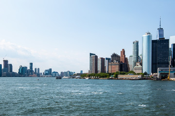 Fototapeta na wymiar New York City / USA - JUL 14 2018: Lower Manhattan Skyline view from Governors Island ferry on a clear afternoon