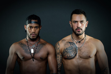 Fashion models with serious faces and fit bodies isolated on black background. Caucasian man with...