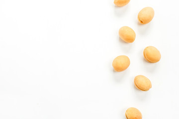 Yellow apricots on white background. Flat lay, top view fruit concept.