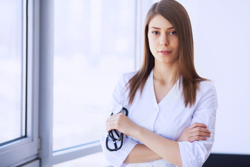 Clinic. Medical physician female doctor over clinic interior background.