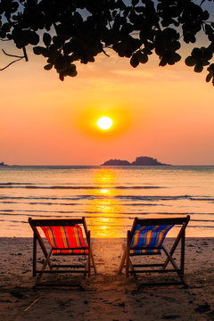 Loungers at the seaside at amazing sunset.