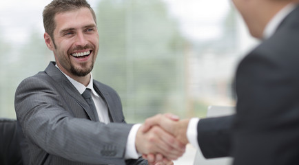 closeup .handshake of business partners on a Desk