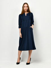 Young beautiful woman posing in new casual winter blue dress