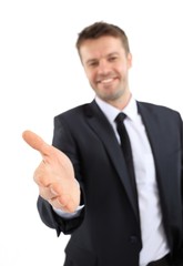 handsome businessman holds out his hand for a handshake.
