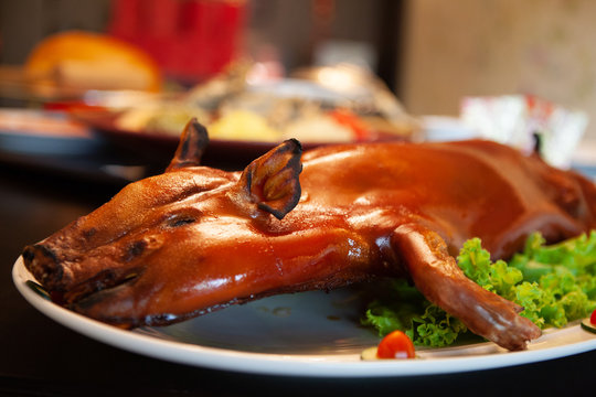 Delicious, Golden Roasted BBQ Suckling pig Cantonese Style made from a piglet that turned into Chinese delicacy which its cooked skin is very crispy and the meat is tender and juicy. Selective Focus.