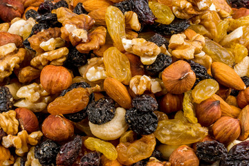 Assorted raisins and prunes nuts on wooden background
