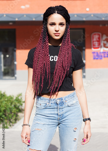 Portrait. Fashionable girl blogger with braids posing