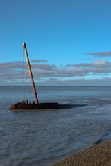 Old boat among blue sky at sunset