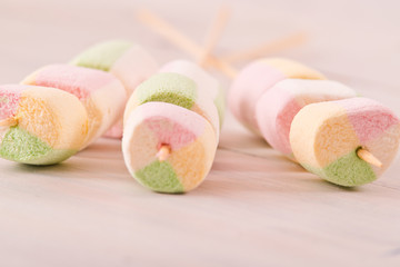 Marshmallows on wooden table.