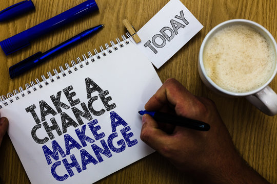 Text sign showing Take A Chance Make A Change. Conceptual photo dont lose opportunity to reach bigger things Man holding marker notebook clothespin reminder wooden table cup coffee.