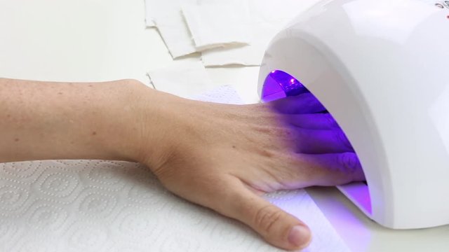 Manicure with led lamp in process