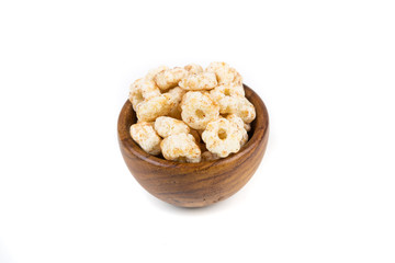 Piles of pale whole grain children's puffed cereal snack