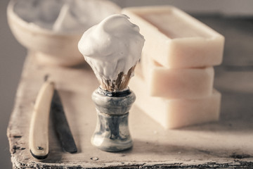Old shaving set with grey soap, razor and brush