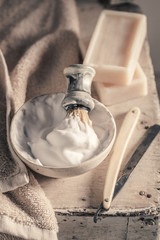 Old barber equipment with grey soap, razor and brush