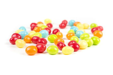 Pile of chewy multicolored shiny gummy candy beans