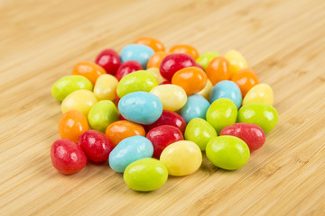 Pile of chewy multicolored shiny gummy candy beans