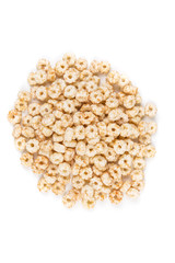 Piles of pale whole grain children's puffed cereal snack