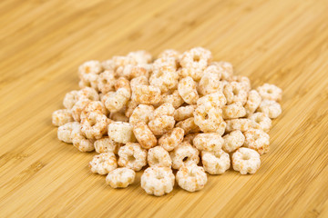 Piles of pale whole grain children's puffed cereal snack