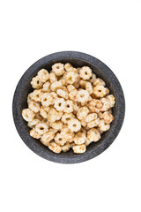 Piles of pale whole grain children's puffed cereal snack