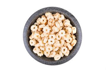 Piles of pale whole grain children's puffed cereal snack