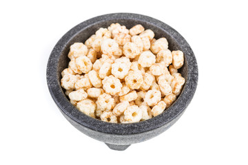 Piles of pale whole grain children's puffed cereal snack