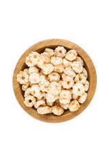 Piles of pale whole grain children's puffed cereal snack