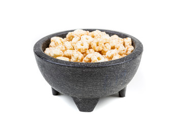 Piles of pale whole grain children's puffed cereal snack