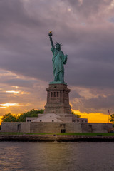 Fototapeta premium Sunset View of Statue of Liberty in New York Harbor