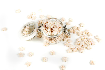 Piles of pale whole grain children's puffed cereal snack