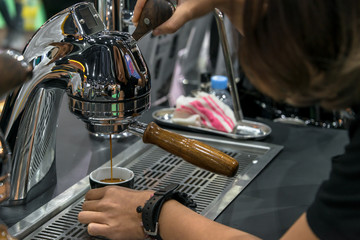 Coffee Espresso with temper in coffee machine pouring fresh a coffee