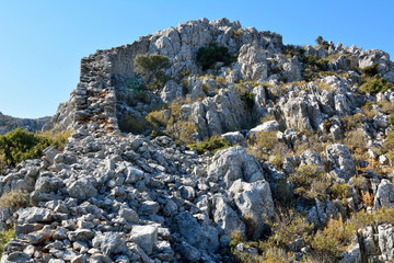 Ruined wall of castle located on the coastline between Sogut and Taslica on Bozburun peninsula near Marmaris resort town in Turkey.