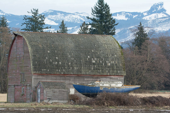 Old barn and sail boat near the Washington coast in skagit county