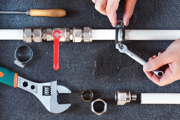 Plumber screwing plumbing fittings,