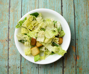 Caesar salad without chicken in a circular white bowl