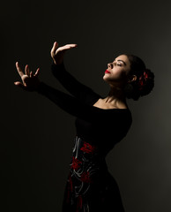 flamenco dancer on a dark background. free space for your text - obrazy, fototapety, plakaty
