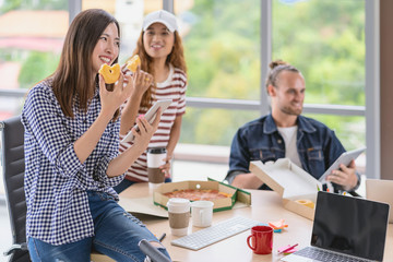 Asian worker  with casual suit talking and eatting with happy action when lunch time in the...