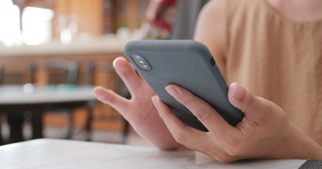 Woman use of mobile phone in restaurant