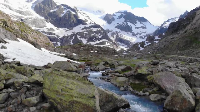 Aerial shot over a waterfall to reveal the Steingletscher in Switzerland