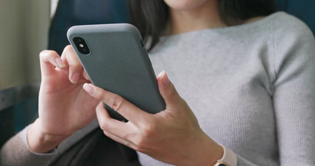 Woman use of smart phone on train