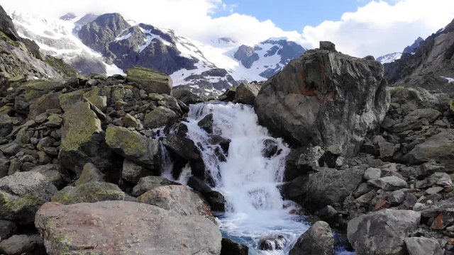 Aerial shot over a waterfall to reveal the Steingletscher in Switzerland